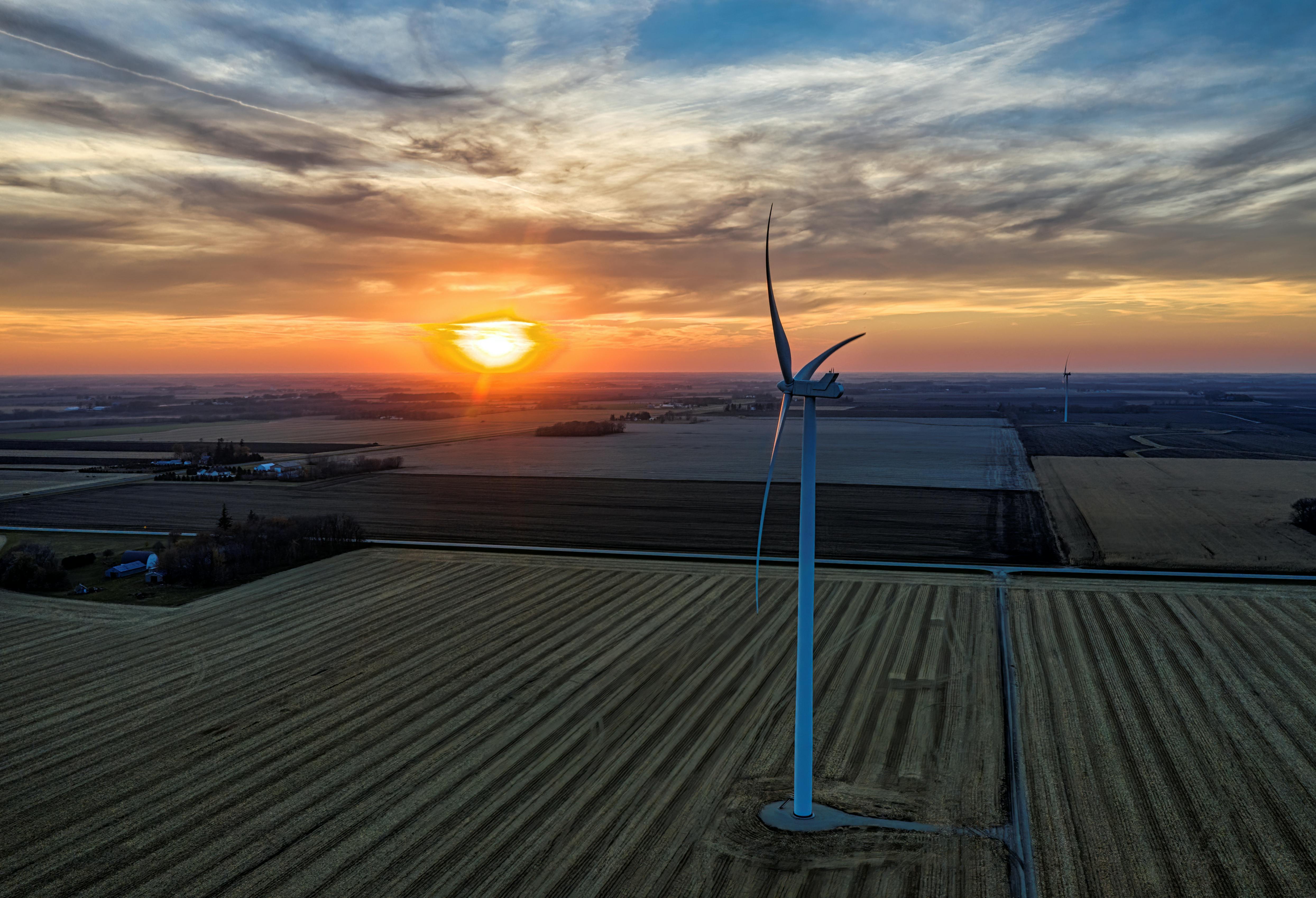 Aerial view of wind turbine at sunset